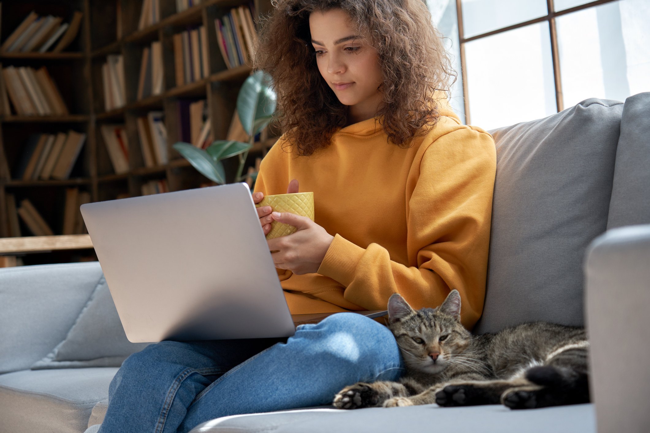 Girl with cat on laptop